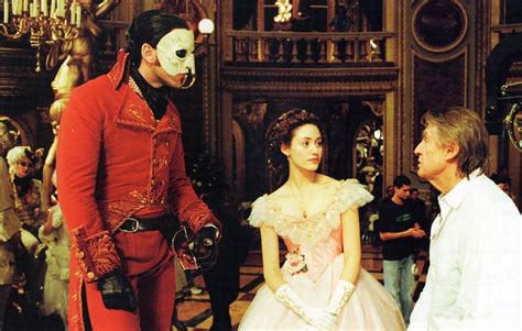 The voice of the actor playing the phantom is awesome, powerful, mesmerizing. Gerard Butler, Emmy Rossum, and Joel Schumacher on set of ...