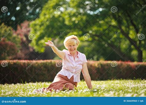 Enjoyment Positive Emotions Outgoing Old Woman Resting On Grass Stock