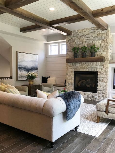 May 31, 2019 · a masculine living room with a stone clad fireplace, wooden tables, a faux fur rug, upholstered furniture and lamps a minimalist masculine living room with a dark wall and sofa, a hex coffee table and lights Pin on TOWNHOME