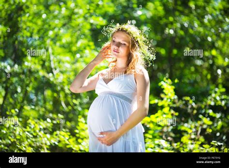 Pregnant Woman In Green Forest Stock Photo Alamy