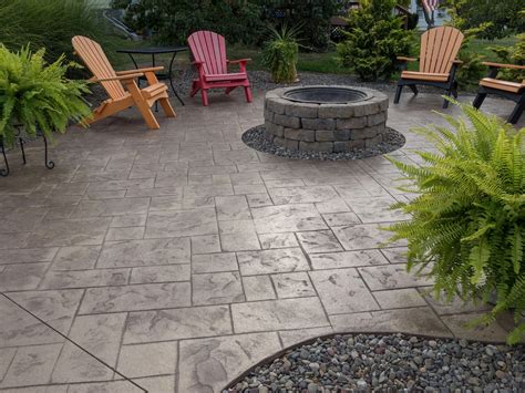Both stamped concrete and pavers are made with concrete. Stamped concrete patio with paver fire pit | Concrete ...