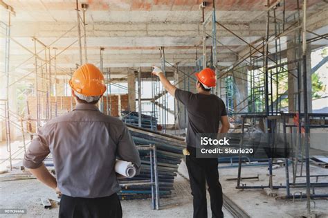 Insinyur Berdiskusi Dengan Mandor Tentang Proyek Di Lokasi Konstruksi