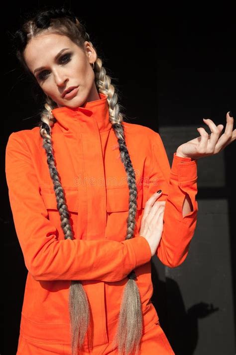 Portrait Of A Beautiful Woman With Braids In Orange Clothes Stock Photo