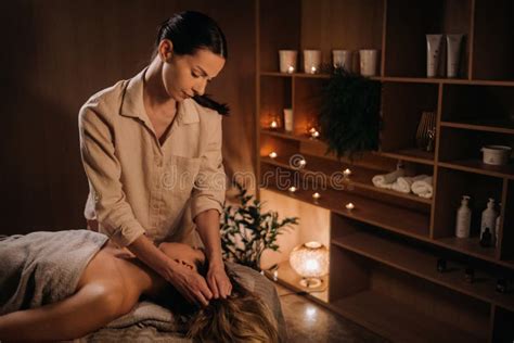 A Masseuse Gives A Body Massage To A Woman In A Spa Center A Professional Masseur Massages The