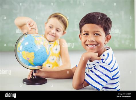 Happy School Kids With Globe In Classroom Stock Photo Alamy