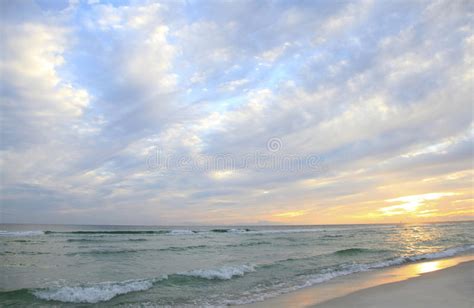 Sunset And Beautiful Clouds On A White Sand Florida Beach Stock Photo