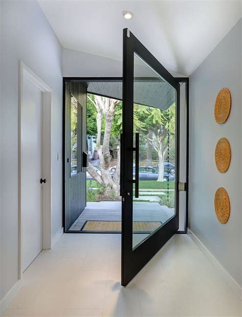 A Huge Pivoting Front Door In Glass And