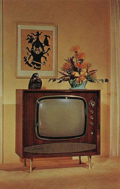 An Old Fashioned Television Sitting On Top Of A Wooden Stand In Front