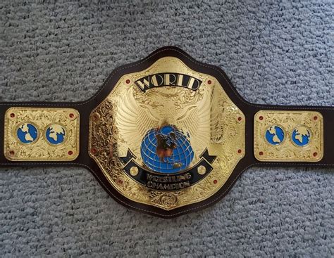 A Wrestling Belt With The Word World On It