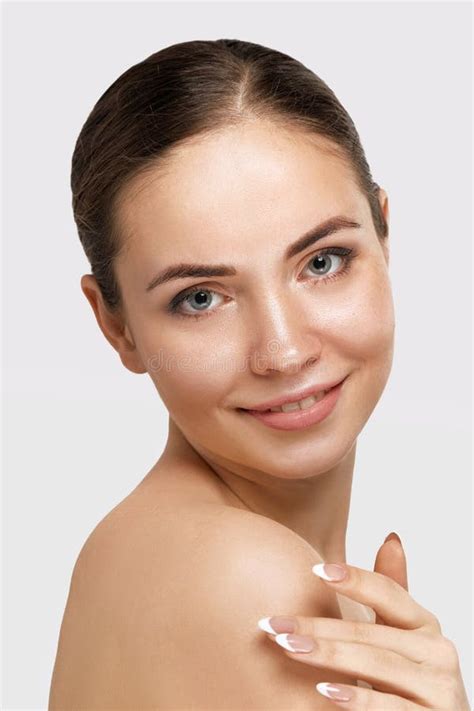 woman face skin care closeup beautiful woman with perfect professional makeup touching her