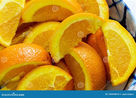 Freshly Squeezed Orange Juice In A Glass Next To A Bowl Of Orange