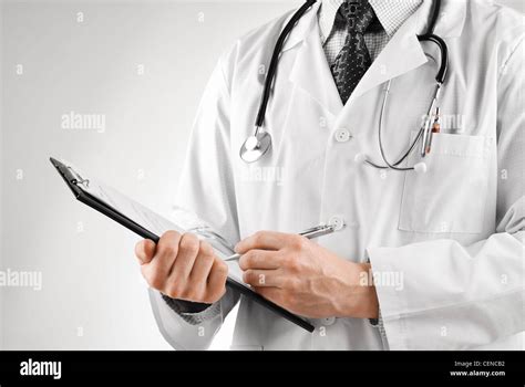 Doctor With Stethoscope Writing Something On Clip Board Stock Photo Alamy