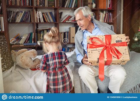 Grandfather Giving Present And Celebration Christmas Time With His