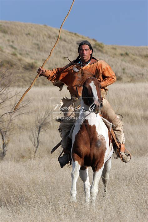 A Native American Lakota Sioux Indian Riding Horseback On The Prairie