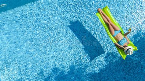 Beautiful Woman In Hat In Swimming Pool Aerial Top View From Above