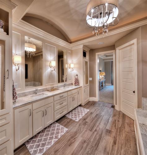 White and gold master bathroom designed with a small tub nook flanked by his and her washstand vanities in white accented with brass pulls. Master bathroom: his and her sink Home Pinterest Master ...