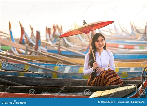 An Asian Woman Holding A Red Umbrella Sitting On A Gondola A Young Burmese Woman With A Red