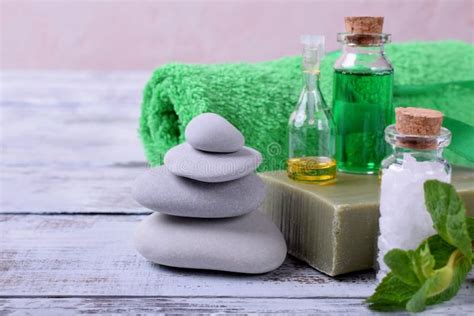 Spa Set Massage Stones Aromatic Oil Sea Salt Green Gel Organic Soap And Green Towel Stock