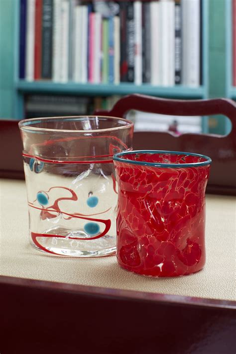 Two Glass Cups Sitting On Top Of A Table