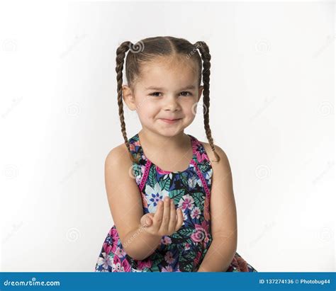 Little Girl With Mischievous Expression Holding Hand Out With Stock
