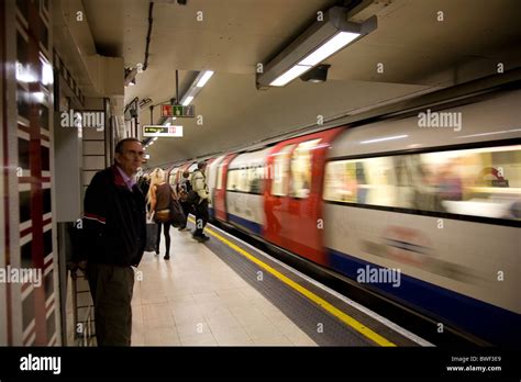 Passengers Waiting For Tube Train On London Underground Station