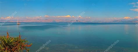 Panoramic Long Exposure Seascape Shot With Boat Blue Cloudy Sky