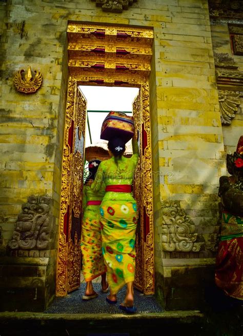 a balinese woman wearing traditional local clothing entering a sacred temple editorial stock