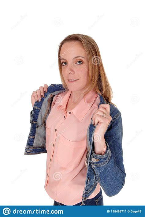 Young Blond Woman Standing Holding Her Jeans Jacket Stock
