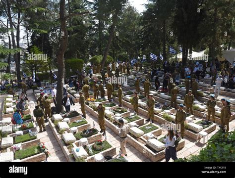 Israeli Soldiers Stand By Graves Of Fallen Soldiers In The Mt Herzl