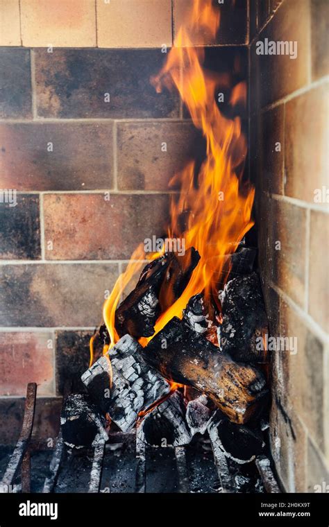 Burning Firewood Making Ready The Embers For A Barbecue Fire In The