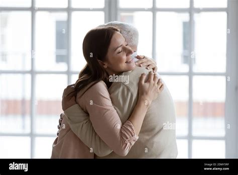 Grownup Daughter Cuddling Senior Dad Meeting After Long Time Separation