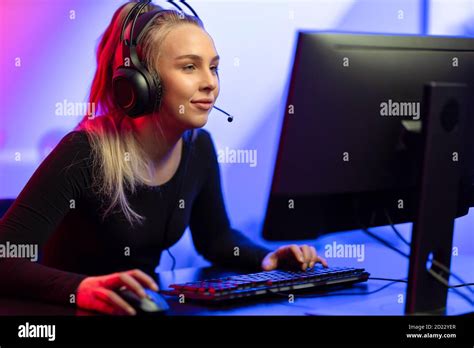 Focused E Sport Gamer Girl With Headset Playing Online Video Game On Pc