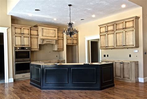 Glazing kitchen cabinets is a budget friendly way to give a kitchen an instant makeover. Frameless, full overlay cream-colored cabinets, with a ...