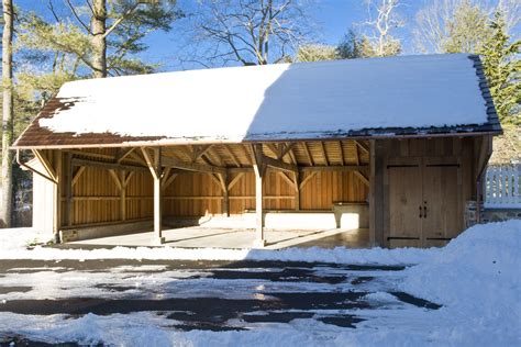 An Open Garage With Snow On The Ground And Trees In The Backgrouds