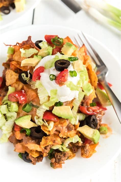 In a large mixing bowl combine egg noodles, cooked chicken, chives, garlic salt, cream of mushroom soup, cream of chicken soup, rotel tomatoes, and corn. This Doritos taco casserole is a weeknight dinner MUST! It ...
