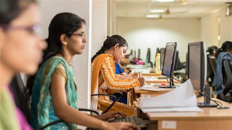 A Young Indian Woman Working At A Computer For Supported Jobs And