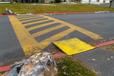 Paved Road Painted With Yellow Diagonal Stripes Between Parallel Lines