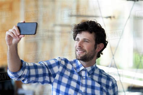 Man Using Smartphone To Take A Selfie Stock Photo Dissolve