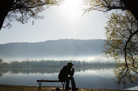 A Man Sitting Quietly Beside Lake Stock Photo Image Of Peace Lonely