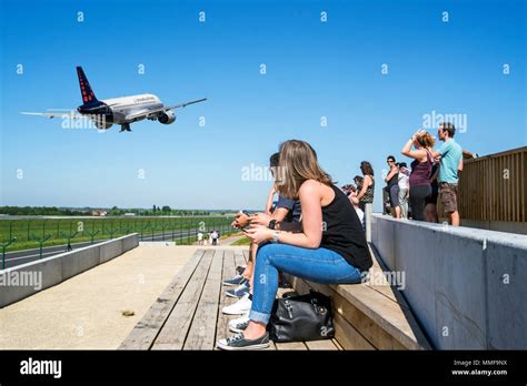 Plane Spotters On Aircraft Spotting Platform Watching Airplane From