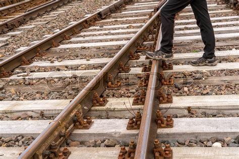 man ilegally crossing train tracks stock image colourbox