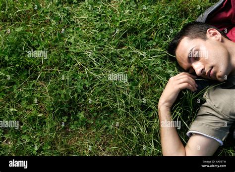 Young Man Sleeping In Sleeping Bag On Grass Stock Photo Alamy