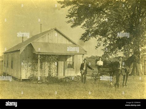 Settlers In Front Of Wooden Home On Homestead During The Late 1800s