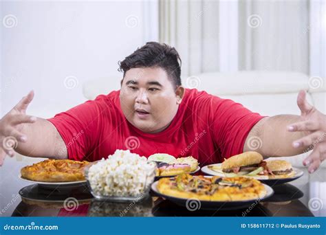 Obese Man Looks Lazy To Eat Food On Studio Stock Image Cartoondealer