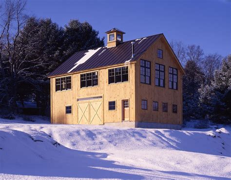 A Large Yellow Building Sitting On Top Of A Snow Covered Field With Trees In The Background