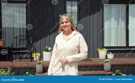 Blonde Real Estate Agent Standing Against New House Offer Stock Footage
