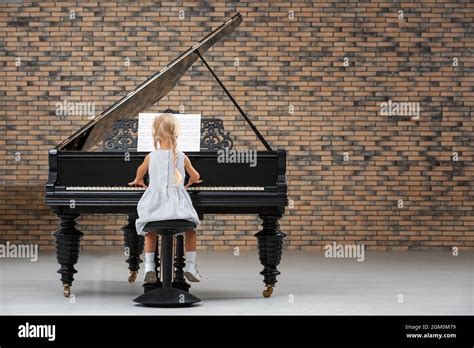 Little Girl Playing Piano Indoors Stock Photo Alamy