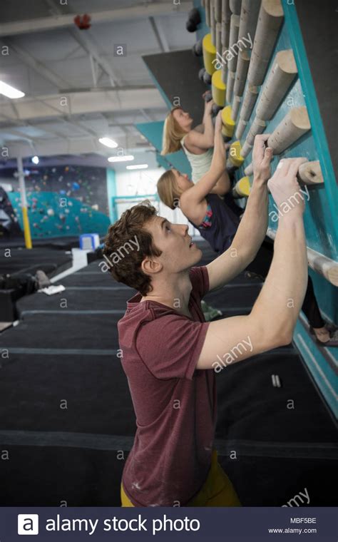 Rock Climbers Climbing Wall At Climbing Gym Stock Photo Alamy