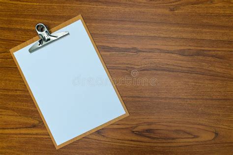 Clipboard With Blank White Paper Sheet On Wood Table Top View With Copy