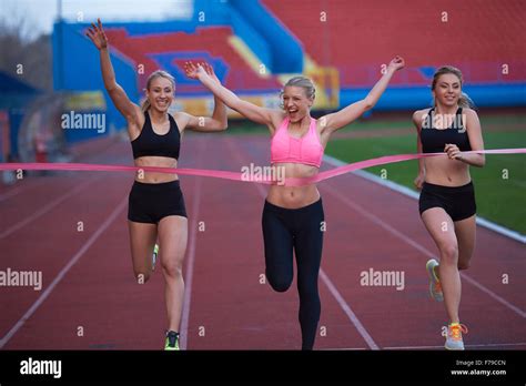 Female Runners Finishing Athletic Race Together Stock Photo Alamy
